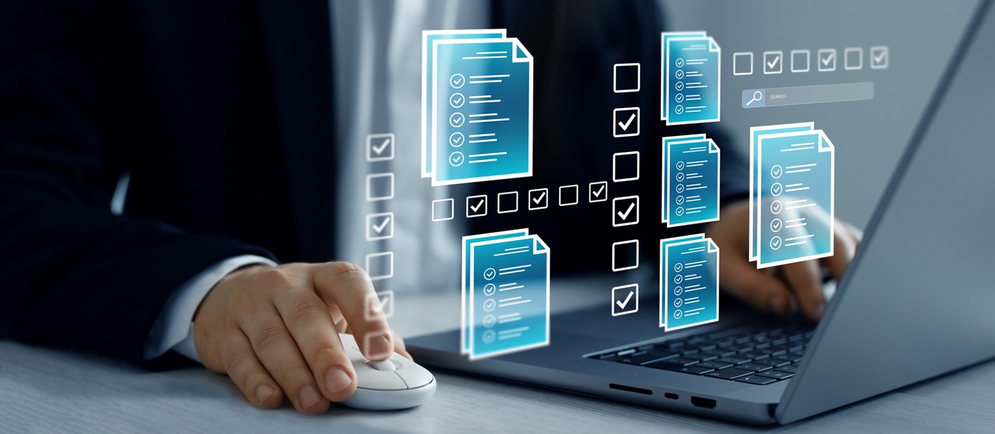 Man working at computer, with graphics of documents and check boxes in the foreground.