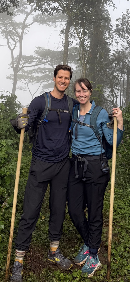 Jason posing with his wife in a forest