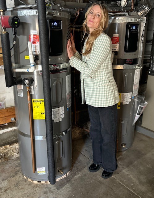 Leanne Hoadley in front of her water heater