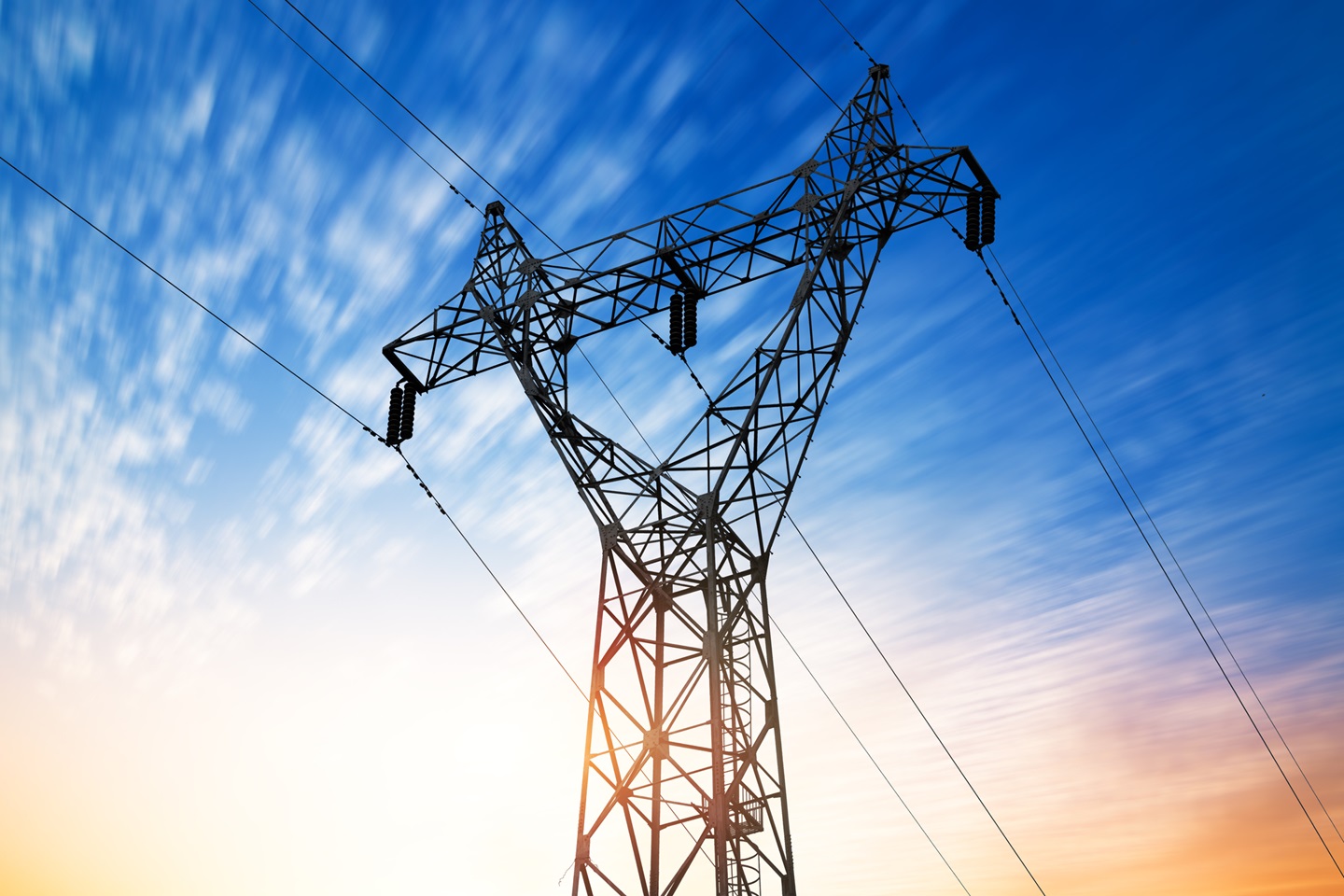 electric transmission tower with dramatic sky in the background