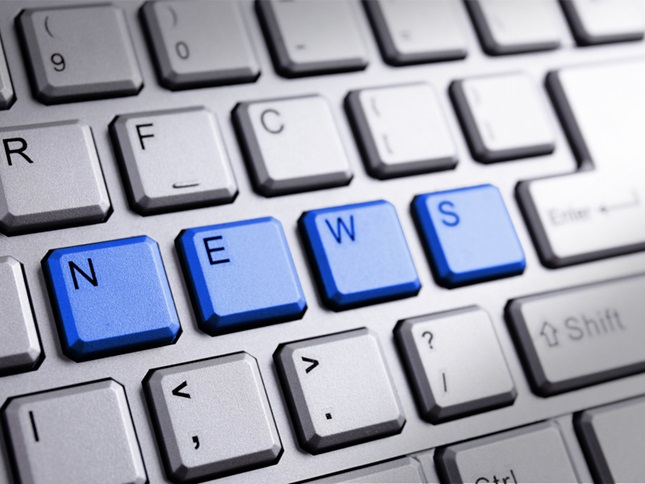 computer keyboard with blue keys spelling out NEWS
