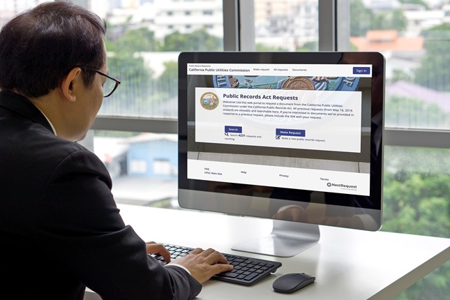 Man looking at the PRA Request website on a desktop computer