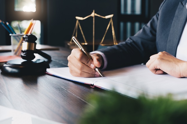 A judge signing a document