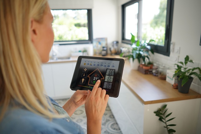 A woman managing her smart phone on a tablet