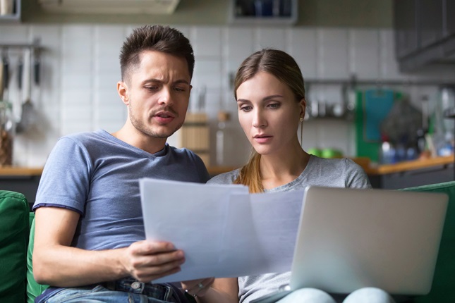 Two partners looking at the bills. 